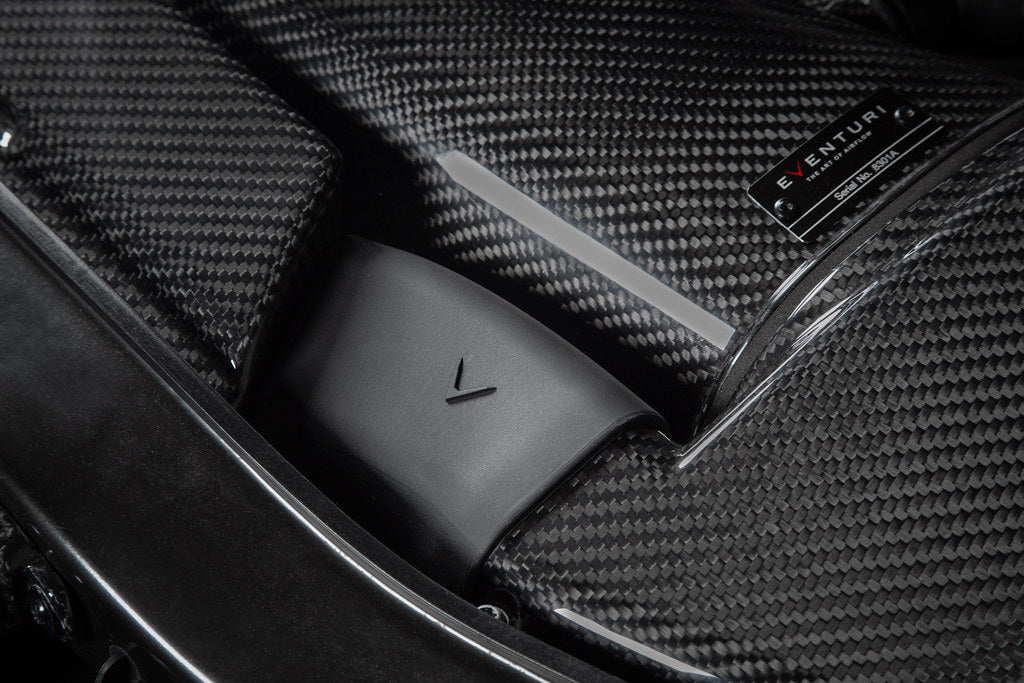Eventuri gloss carbon fiber duct set installed in the engine bay of a red BMW E92 M3 Coupe