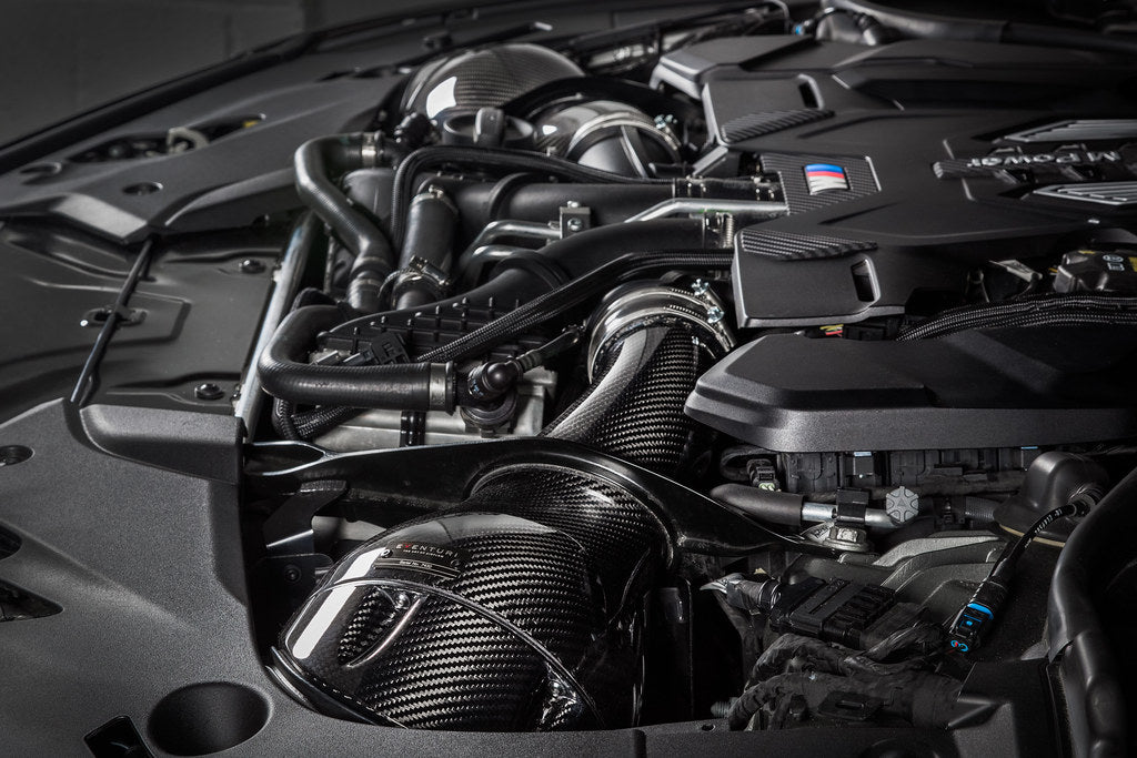 Eventuri Black Carbon Intake System installed in the engine bay of a BMW F90 M5 and F9X M8 featuring pre-preg carbon fiber intake housings and turbo inlet system.