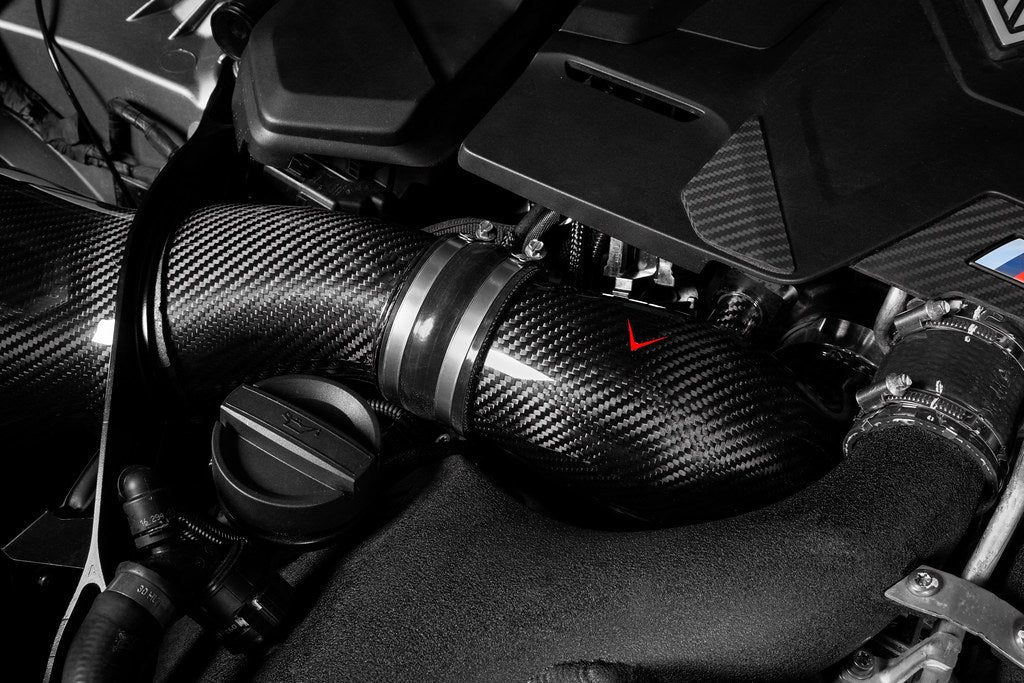 Eventuri BMW F90 M5 and F9X M8 carbon turbo inlet set installed in engine bay, showcasing performance engine components.