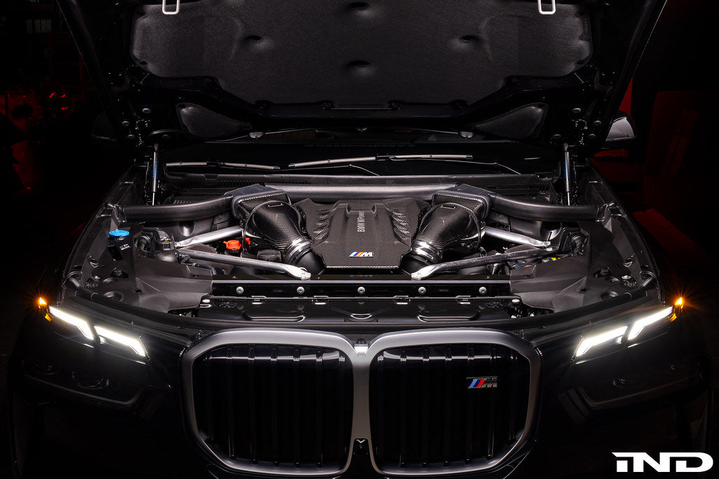 Eventuri black carbon intake system installed in BMW F95 X5M G09 XM engine bay, showcasing performance air intake components.