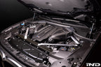 Eventuri black carbon intake system installed in engine bay of BMW F95 X5M, X6M, G09 XM, M60i performance vehicle