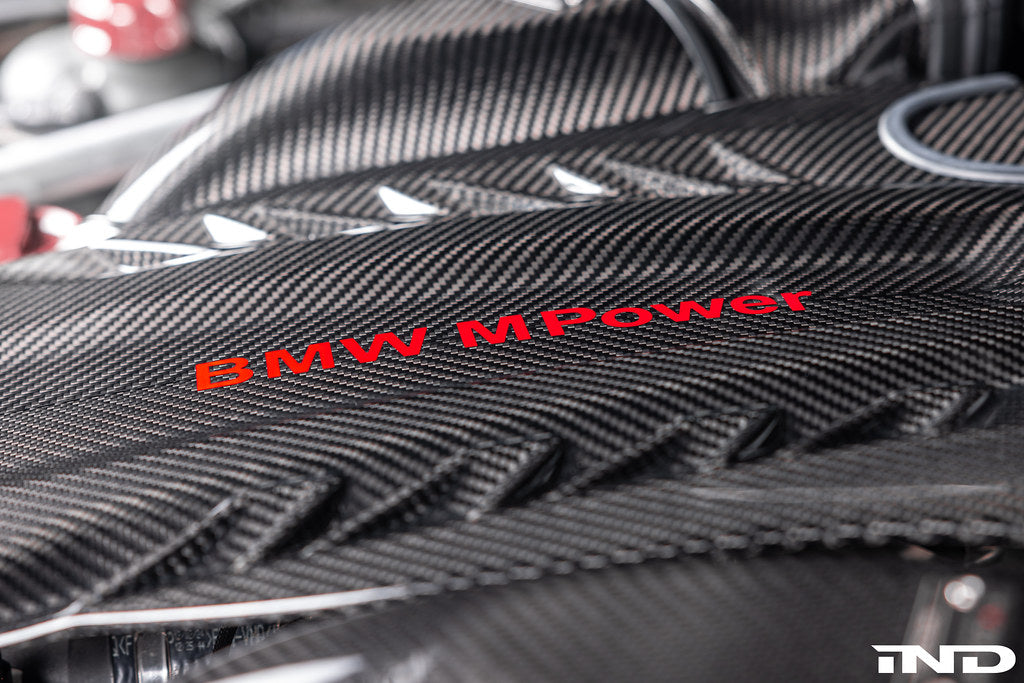 Eventuri black carbon intake system installed in BMW F95 X5M with S63 engine, showcasing performance air intake in the engine bay.