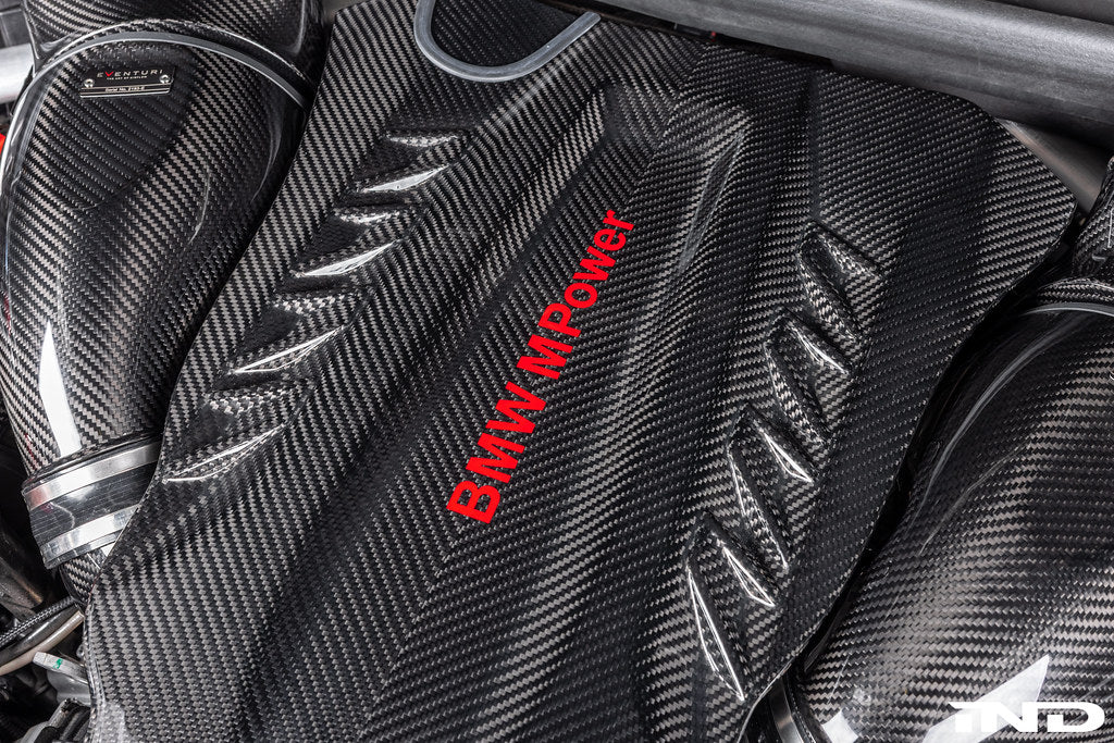 Eventuri black carbon intake system installed in BMW F95 X5M G09 XM engine bay, showcasing performance air intake for BMW M models.