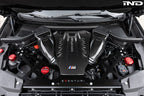 Eventuri black carbon intake system installed in BMW F95 X5M with S63 engine, showing performance air intake in engine bay.
