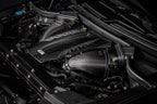 Eventuri black carbon intake system installed in engine bay of BMW F95 X5M, X6M, G09 XM, M60i performance vehicle.