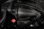 Eventuri black carbon intake system installed in BMW F95 X5M G09 XM engine bay, showcasing performance air intake components.