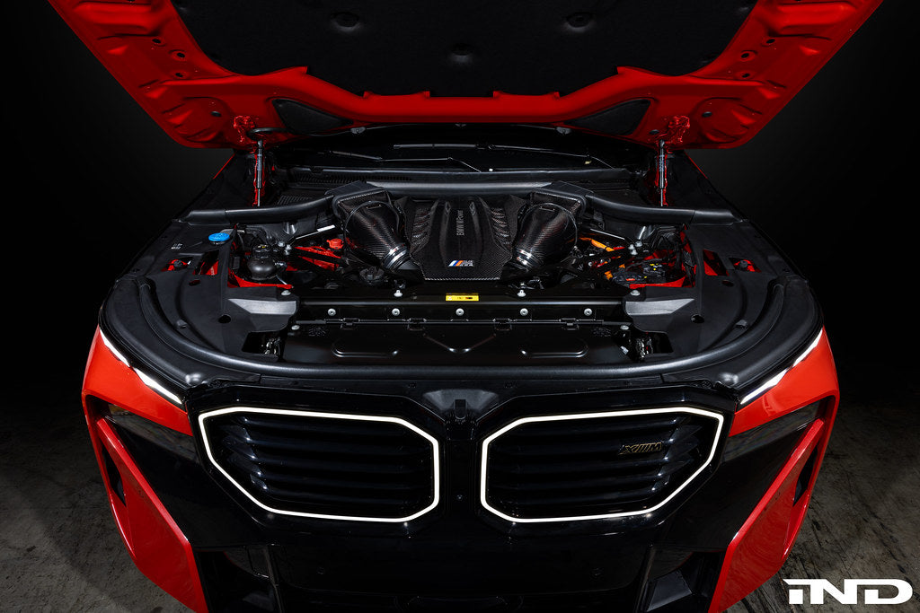 Eventuri black carbon intake system installed in BMW F95 X5M G09 XM engine bay, showcasing performance air intake components.