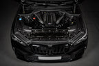 Eventuri black carbon performance intake system installed in BMW F95 X5M engine bay, enhancing airflow and engine performance.
