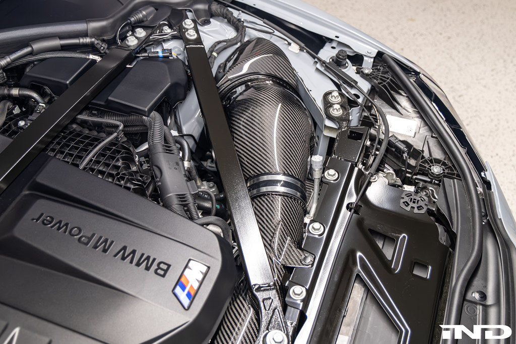 Eventuri black carbon intake system for BMW G8X M2, M3, M4 S58 engine installed in engine bay, V2 performance upgrade.