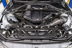 Eventuri black carbon intake system for BMW G8X M2, M3, M4 S58 engine installed in engine bay, V2 performance upgrade.