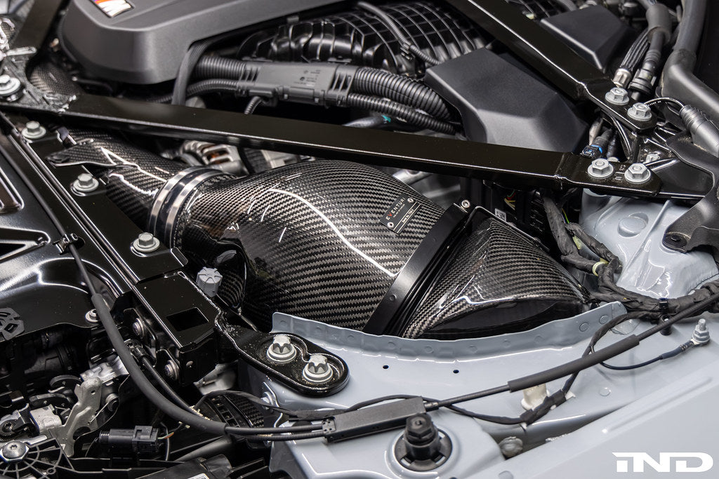 Eventuri black carbon intake system for BMW G8X M2, M3, M4 S58 engine installed in engine bay, V2 performance upgrade.