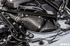 Eventuri black carbon intake system for BMW G8X M2, M3, M4 S58 engine installed in engine bay, V2 performance upgrade.