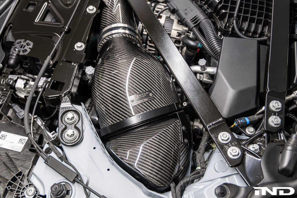 Eventuri black carbon intake system for BMW G8X M2, M3, M4 S58 engine installed in engine bay, V2 performance upgrade.