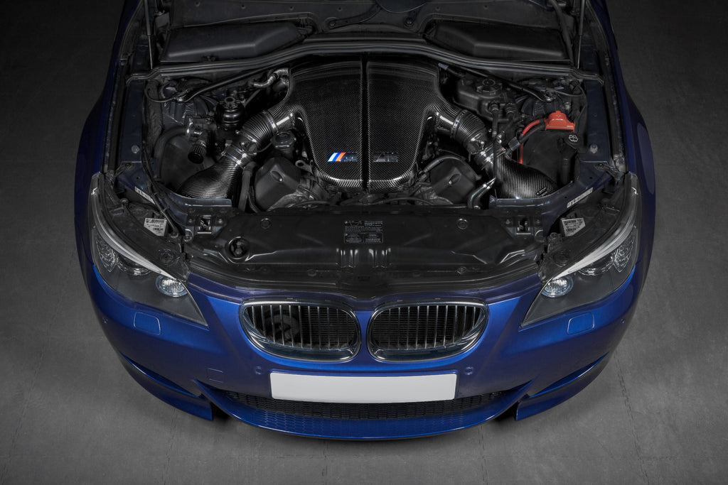 Overhead installed view of Eventuri BMW S85 carbon plenum system in V10 engine bay with optional intake installed