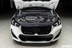 Eventuri black carbon intake system installed in a BMW X1 M35i, showcasing performance upgrade on a white vehicle.