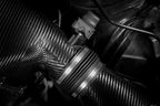 Eventuri hybrid carbon airbox system installed in BMW Z4 M engine bay, showcasing high-performance air intake components.