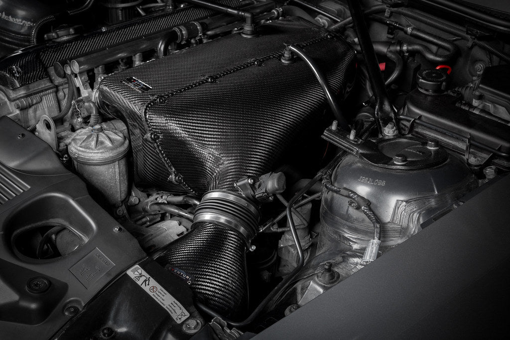 Eventuri hybrid carbon airbox system installed in BMW Z4 M engine bay, showcasing performance air intake components.