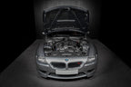 Eventuri hybrid carbon airbox system installed in BMW Z4M engine bay, showcasing performance-oriented design and sleek carbon fiber finish.