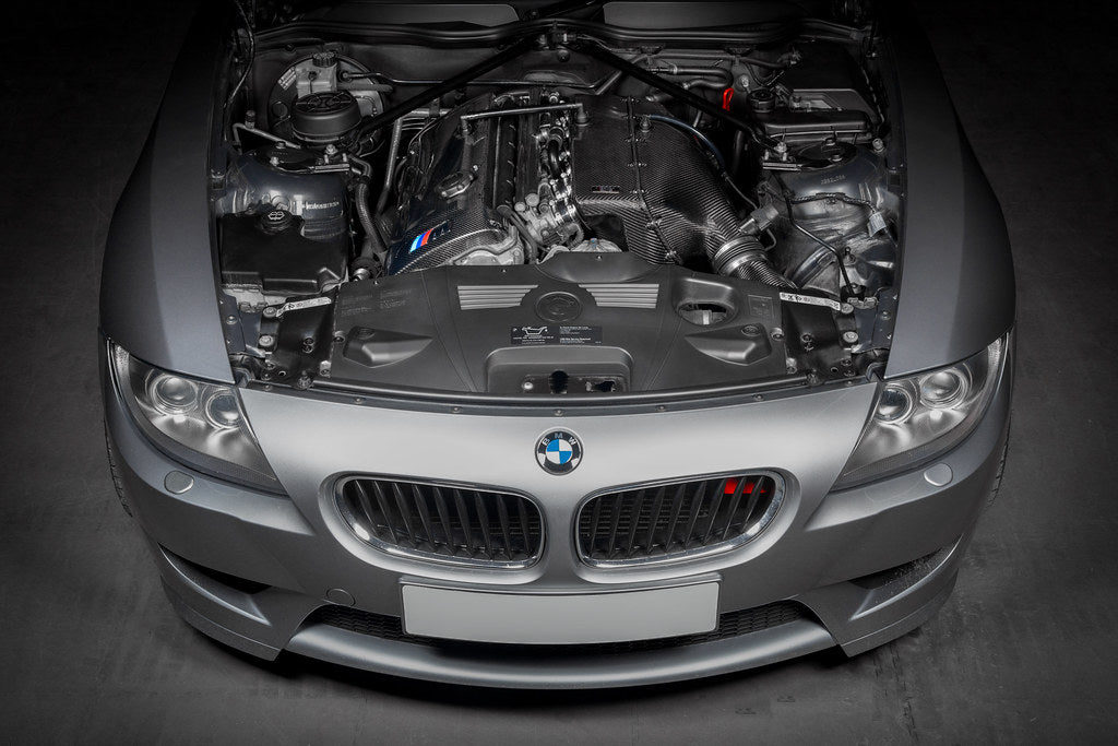 Eventuri hybrid carbon airbox system installed in BMW Z4 M engine bay, showcasing performance-enhancing engine components.