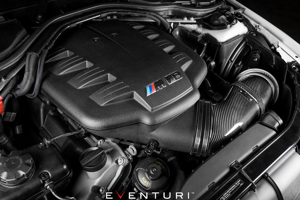 Eventuri black carbon intake system installed in BMW E9X M3 engine bay, showcasing glossy performance air intake for the S65 engine