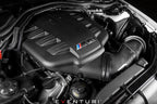 Eventuri black carbon intake system installed in BMW E9X M3 engine bay, showcasing glossy performance air intake for the S65 engine