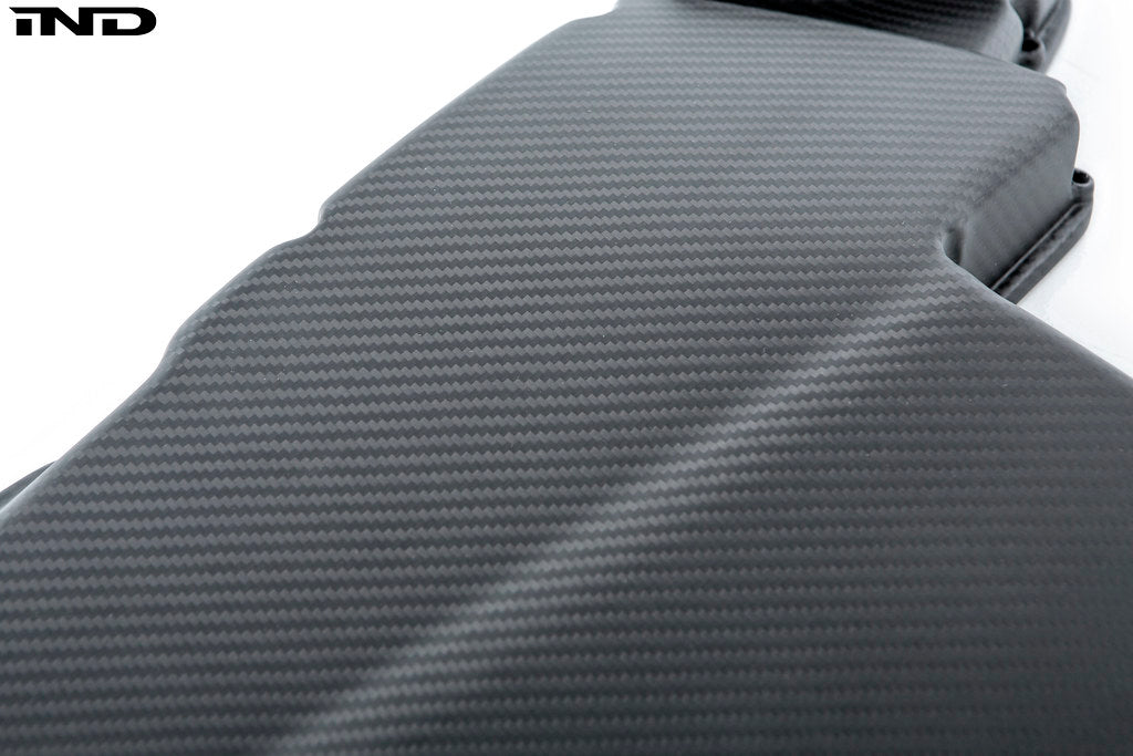 Close-up product photo of Eventuri E9X M3 S65 matte black carbon airbox lid on a white background
