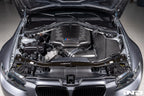 Eventuri black carbon inlet plenum installed in engine bay on BMW E9X M3 S65, showcasing glossy performance upgrade.