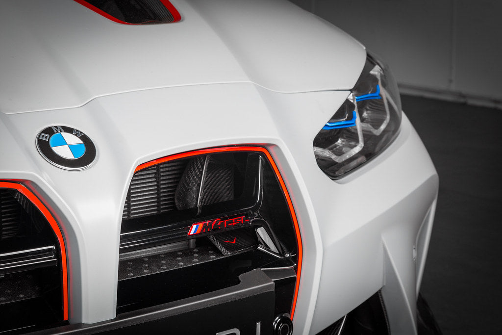 Eventuri black carbon intake scoops installed on BMW G8X M3 and M4, showcasing performance upgrade and aerodynamic design.