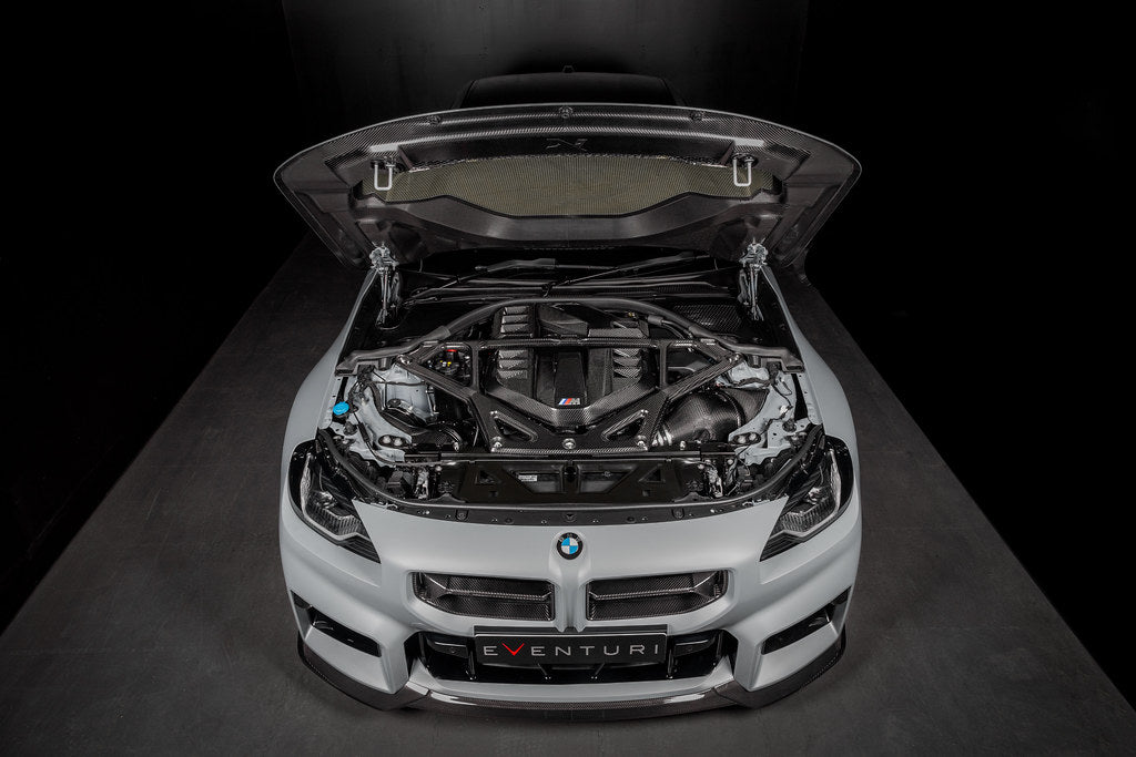 Eventuri gloss carbon CSL strut brace installed on BMW G8X M3 S58 engine bay