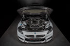 Eventuri gloss carbon CSL strut brace installed on BMW G8X M3 S58 engine bay