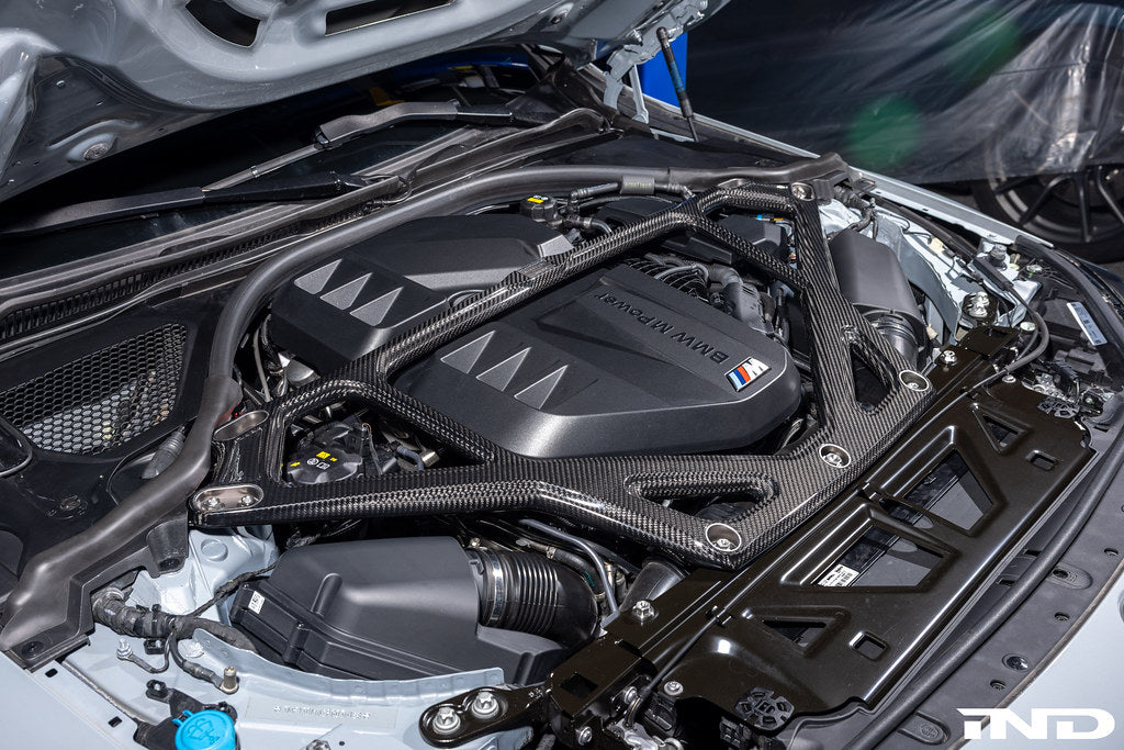 Eventuri gloss carbon CSL strut brace installed on BMW G8X M3 S58 engine bay