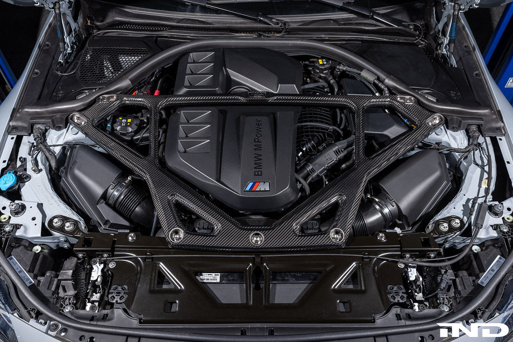 Eventuri gloss carbon CSL strut brace installed on BMW G8X M3 S58 engine bay
