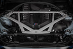 Eventuri black carbon engine cover installed on BMW G8X M2, M3, M4 S58 engine bay, showcasing sleek exterior engine bay enhancement.