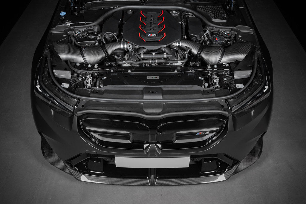 Car engine compartment with visible branding on a dark background