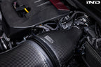 Eventuri GR Corolla carbon intake system installed in engine bay, showcasing glossy carbon fiber finish for enhanced performance.