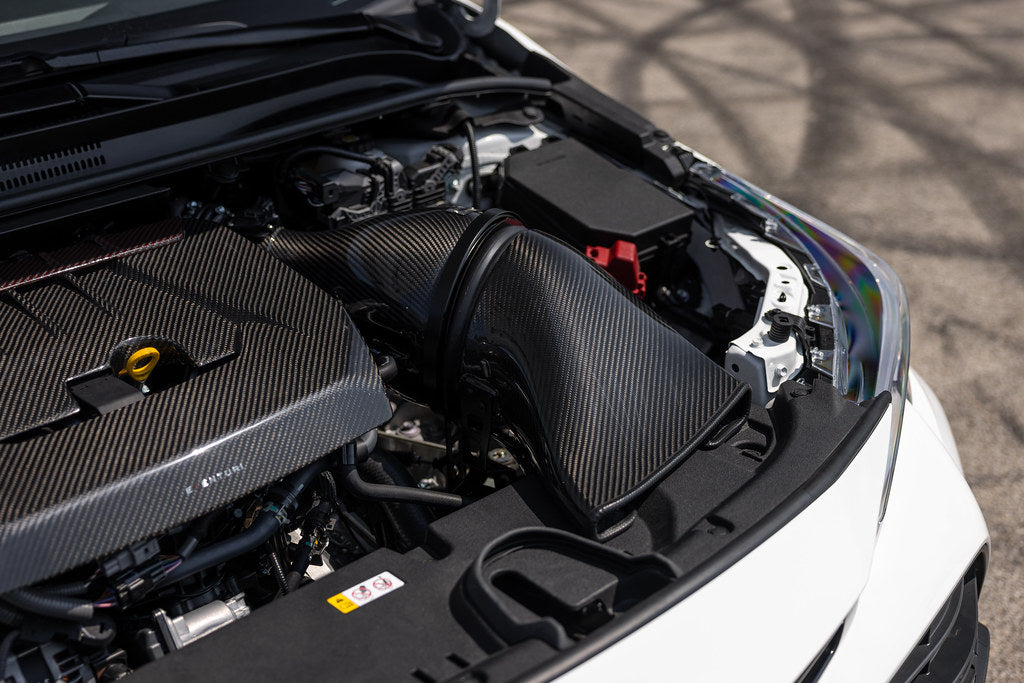 Eventuri GR Corolla carbon intake system installed in engine bay, showcasing a glossy, performance-focused intake setup.