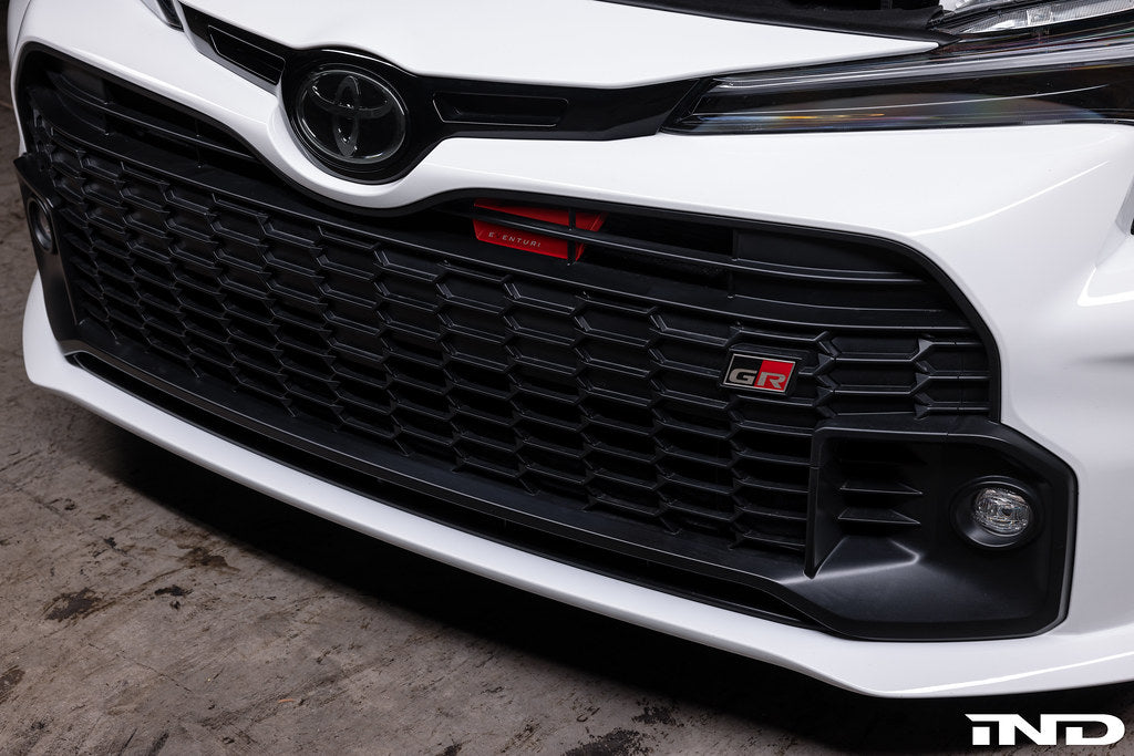 Eventuri GR Corolla carbon intake system installed in engine bay, showcasing glossy carbon fiber performance air intake for enhanced engine airflow.