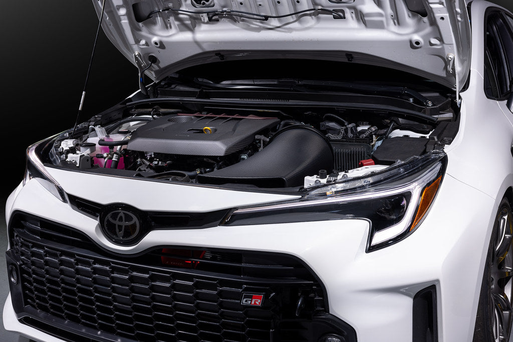 Eventuri GR Corolla carbon intake system installed in engine bay, showcasing matte finish and performance-focused design.