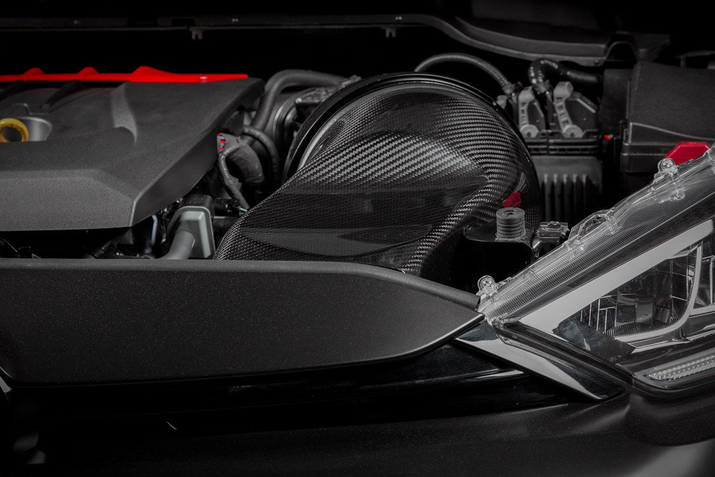 Glossy carbon intake system installed in a GR Yaris by Eventuri, showcasing its sleek, high-performance design.
