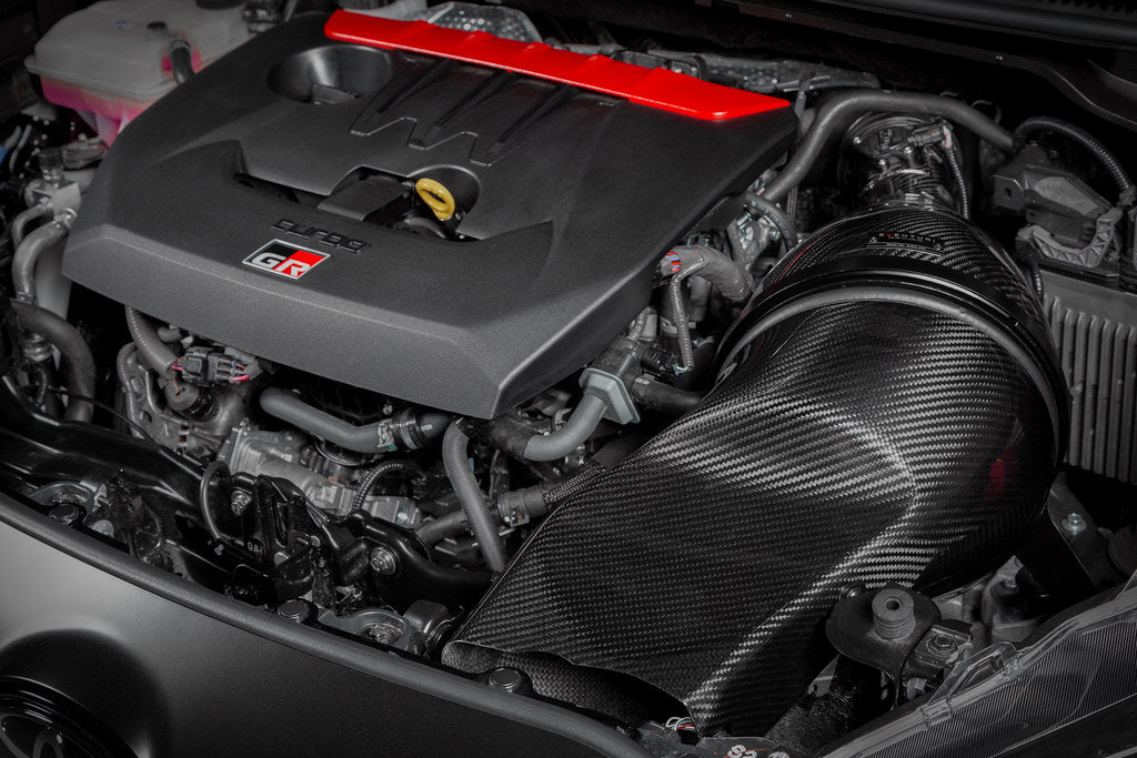 Eventuri GR Yaris Carbon Intake System installed, showcasing glossy carbon fiber performance air intake for improved engine airflow.