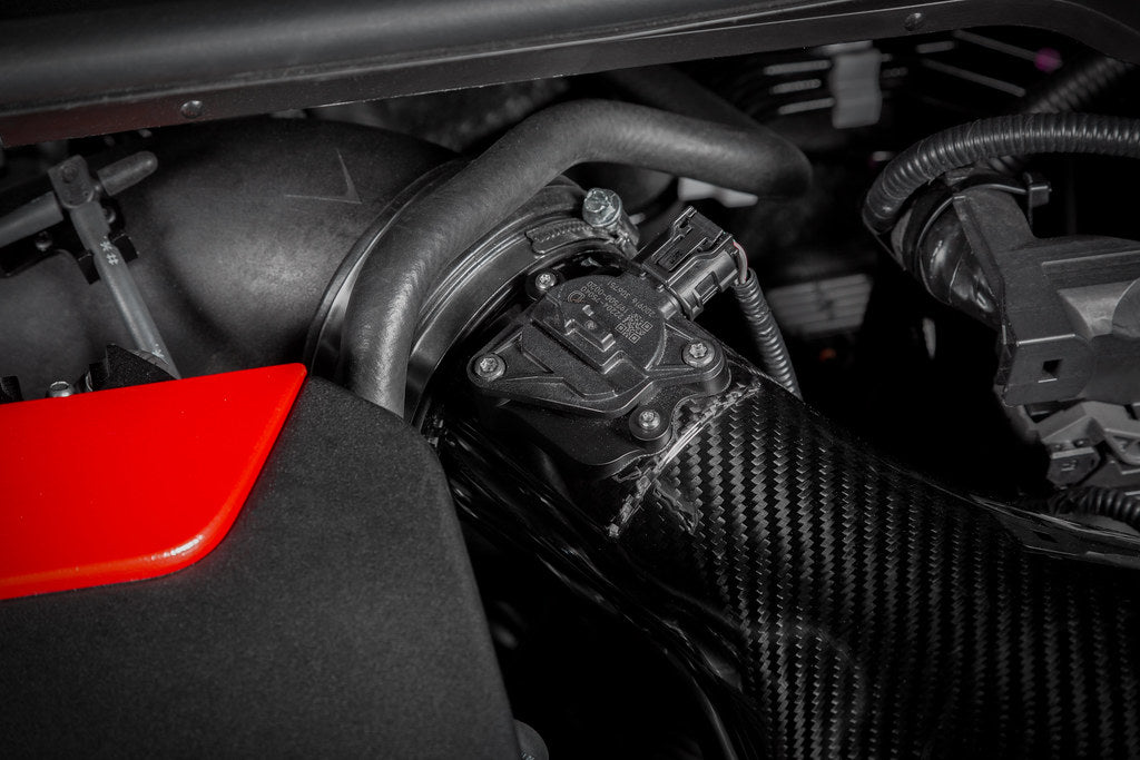 Eventuri GR Yaris carbon intake system installed, showing the glossy, lightweight carbon fiber performance air intake.