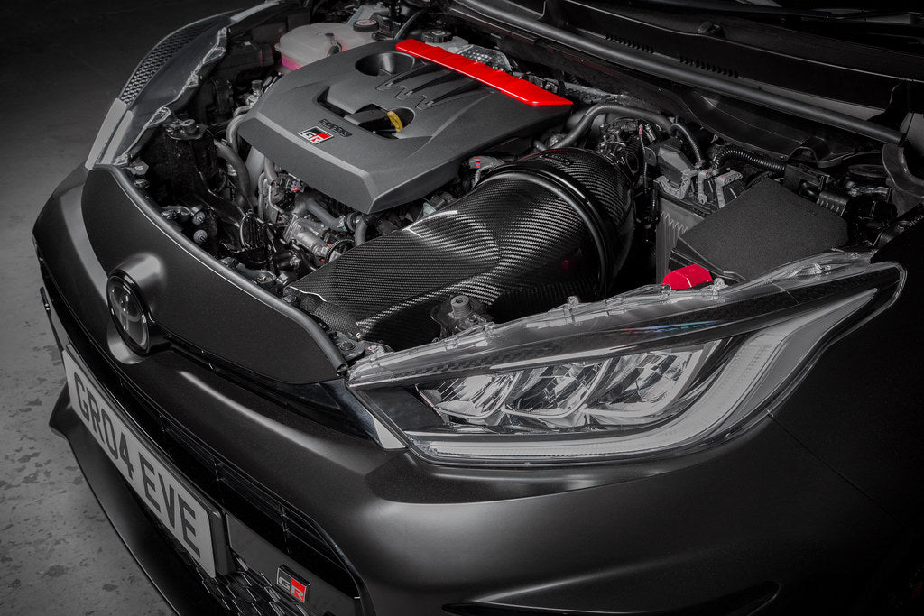 Eventuri GR Yaris Carbon Intake System installed, showcasing glossy carbon fiber performance air intake for enhanced engine airflow.