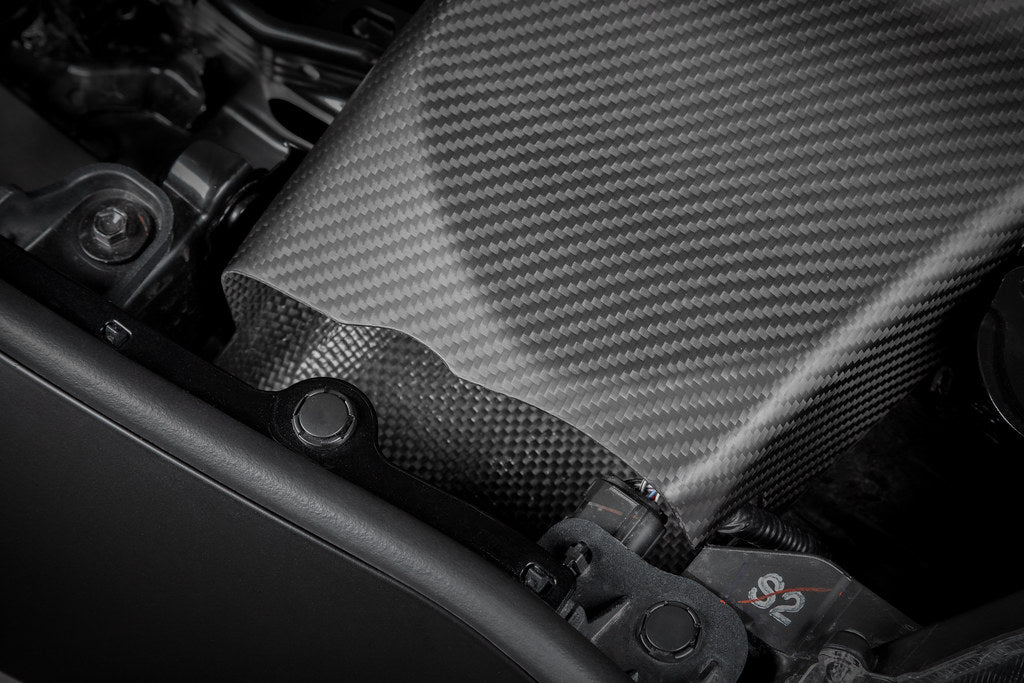 Eventuri GR Yaris carbon intake system installed, showcasing matte finish and performance-focused design on a compact sports car.