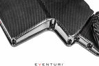 Eventuri black gloss carbon airbox lid for BMW E9X M3 S65 engine, close-up showing sleek, high-quality performance car part.