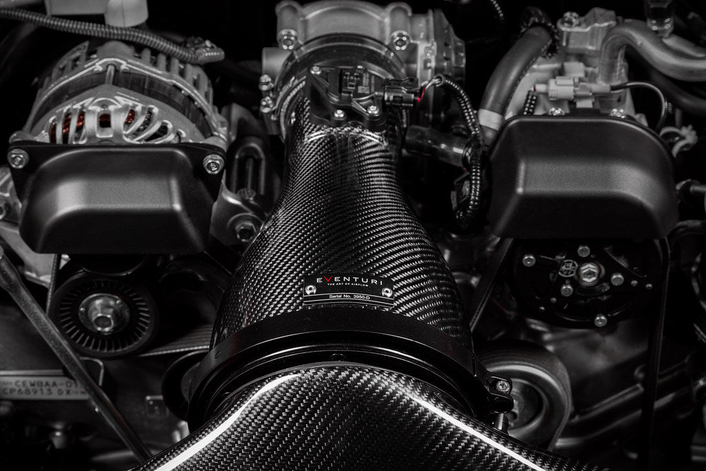 Eventuri Toyota GR86 carbon intake system showing dual feed inlet duct and carbon fiber housing detail in engine bay