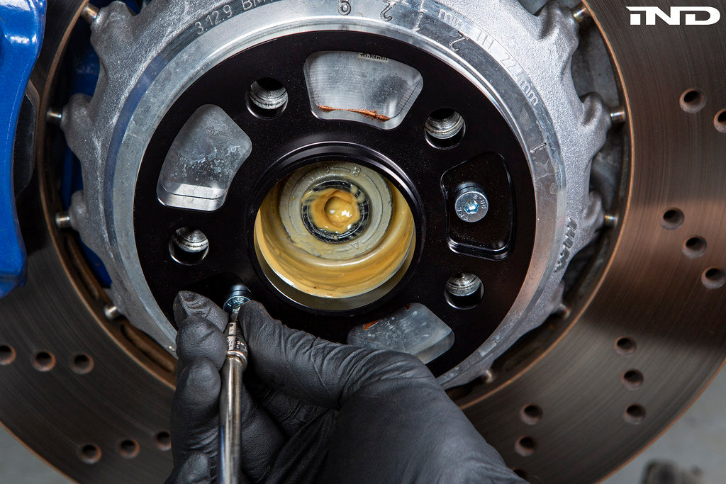 FC BMW 5x112 wheel spacer mounted on BMW hub showing hub centric fitment before wheel install