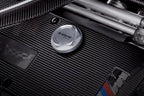 Goldenwrench BMW M Blackline Oil Cap Heritage Motorsport installed on engine exterior, featuring sleek black design and branding.