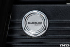 Goldenwrench BMW M Blackline Heritage Motorsport oil cap installed on the engine exterior, showcasing sleek black design.