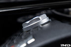 Goldenwrench BMW M Blackline Oil Cap Heritage Motorsport installed on car exterior, showcasing sleek black design and branding.