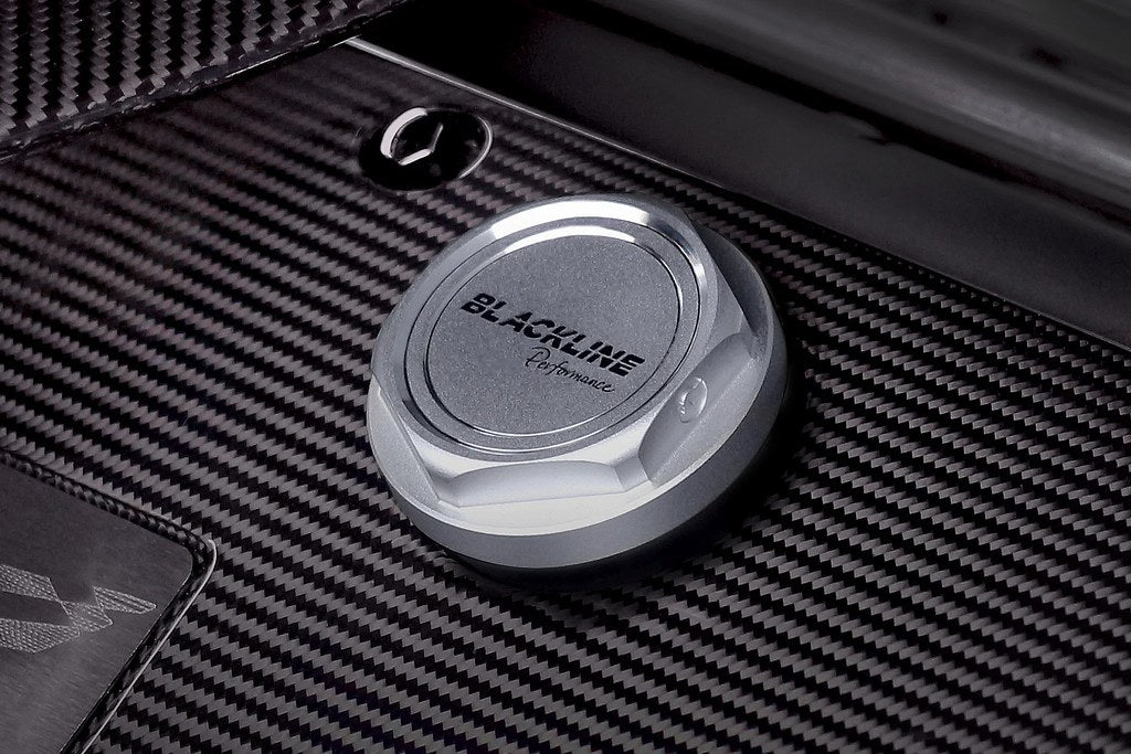 Goldenwrench BMW M Blackline Oil Cap Heritage Motorsport installed on engine exterior, featuring a sleek black design and branding.